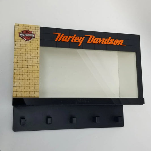 Black Harley Davidson wall key rack with orange logo, brick pattern panel, and four hooks.