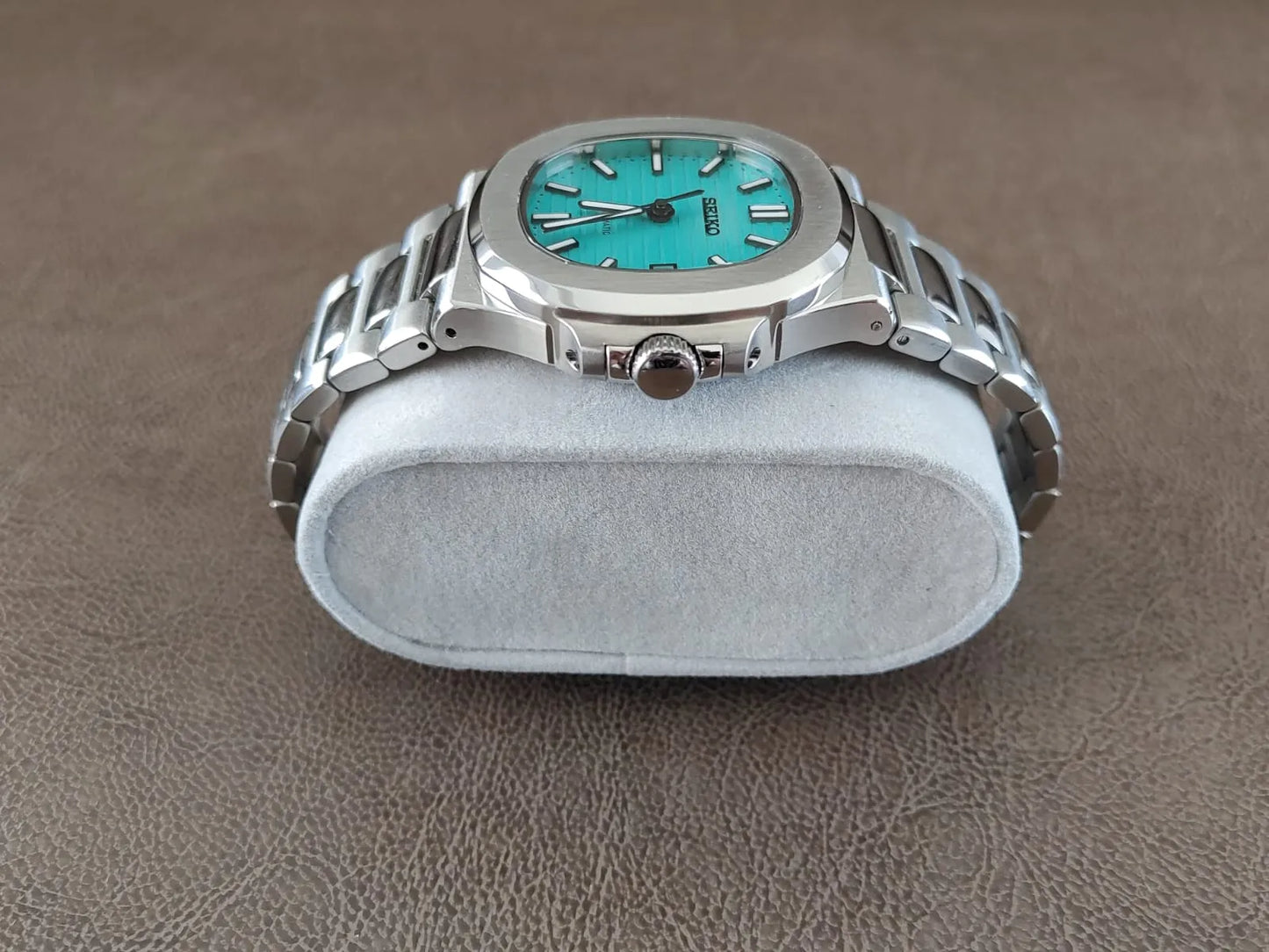 Luxury watch with Tiffany green dial, silver stainless steel case and bracelet, round 40mm face.