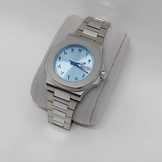 Seiko 40mm stainless steel watch with ice blue dial, Arabic numerals, day-date display, and metal link bracelet.