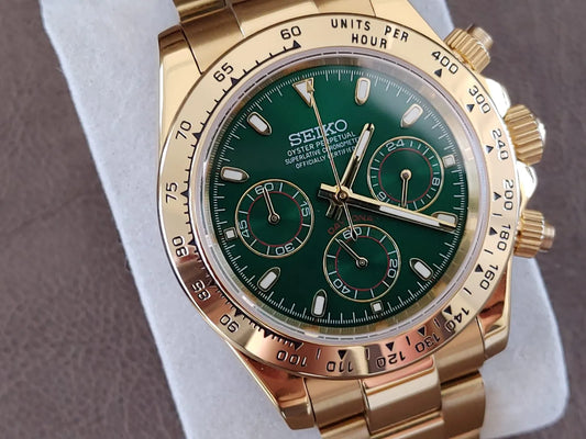 Gold stainless steel Seiko chronograph watch with green dial and three subdials, 40mm case.