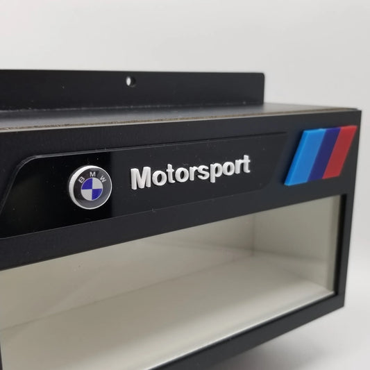 Black wall-mounted key hook rack with clear display case, BMW logo, Motorsport text, and tri-color stripes.