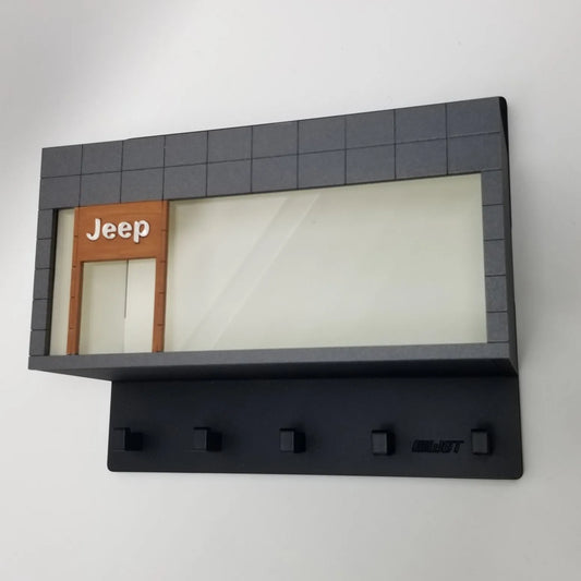 Black Jeep wall key hook rack with glass display case and five metal hooks.
