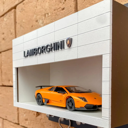 White rectangular wall display case with Lamborghini logo and orange scale model car inside.