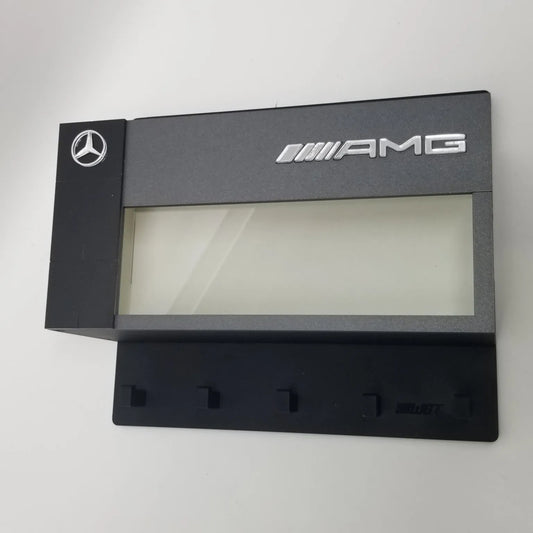 Black Mercedes AMG wall-mounted key hook rack with five hooks and display case window.