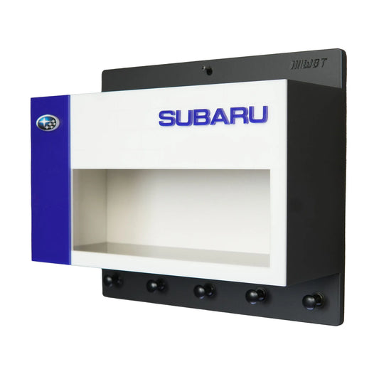 Black and white Subaru wall key hook rack with blue accent and display shelf.
