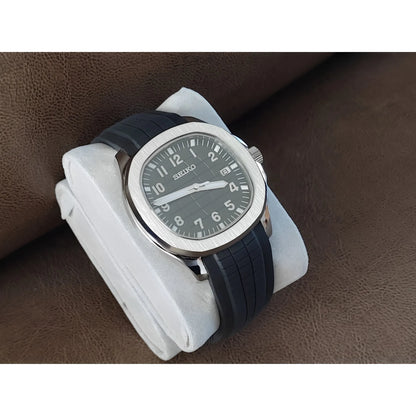 Seiko Aquanaut 40mm watch with black dial, white Arabic numerals, luminous hands, and black rubber strap.