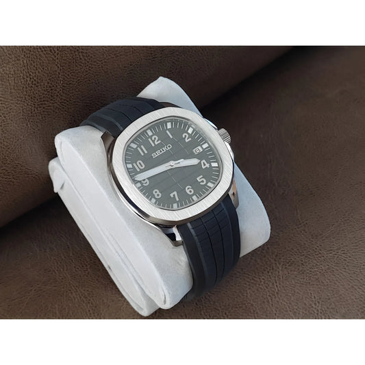 Seiko Aquanaut 40mm watch with black dial, white Arabic numerals, luminous hands, and black rubber strap.