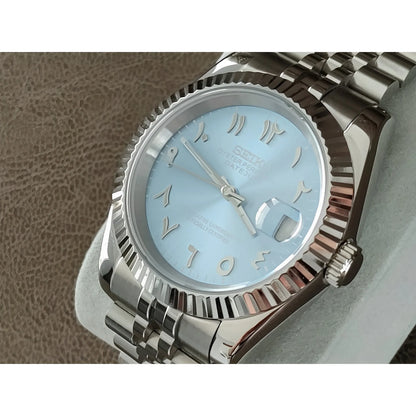 Silver stainless steel watch with fluted bezel, ice blue dial, and silver Arabic numerals.