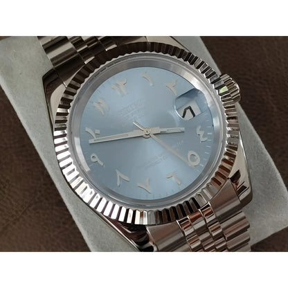 Seiko watch with 39mm ice blue dial, Arabic numerals, chromed indices, fluted bezel, and stainless steel bracelet.