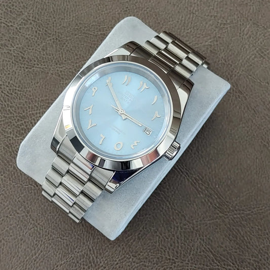 Seiko watch with ice blue dial featuring Arabic numerals and silver President bracelet.