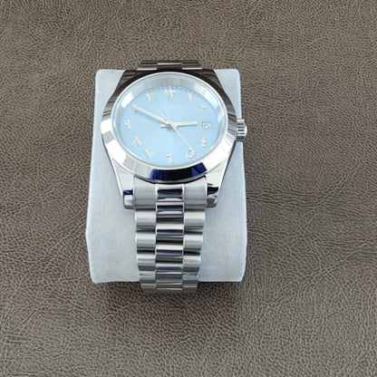 Seiko watch with 39mm platinum case, fluted bezel, ice blue dial, silver Arabic numerals, and stainless steel Jubilee.