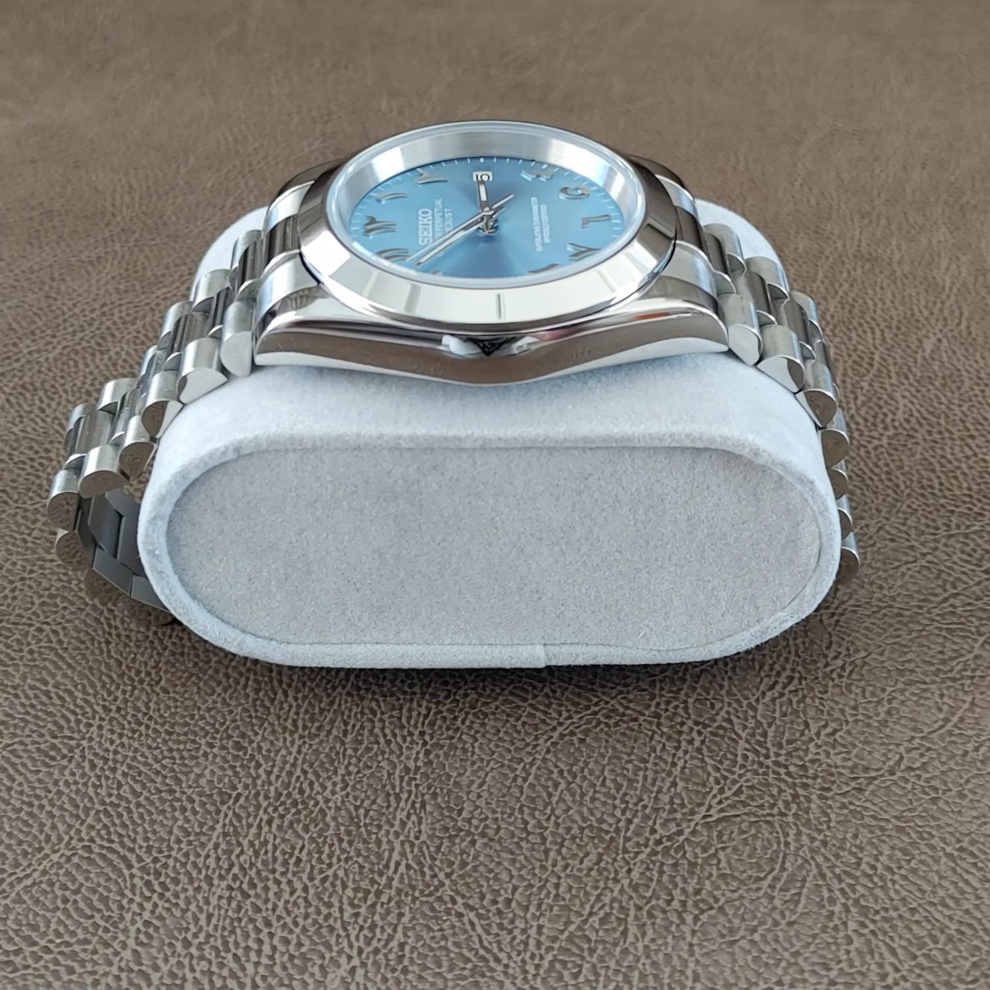Seiko 39mm watch with ice blue Arabic dial and polished silver President-style bracelet.