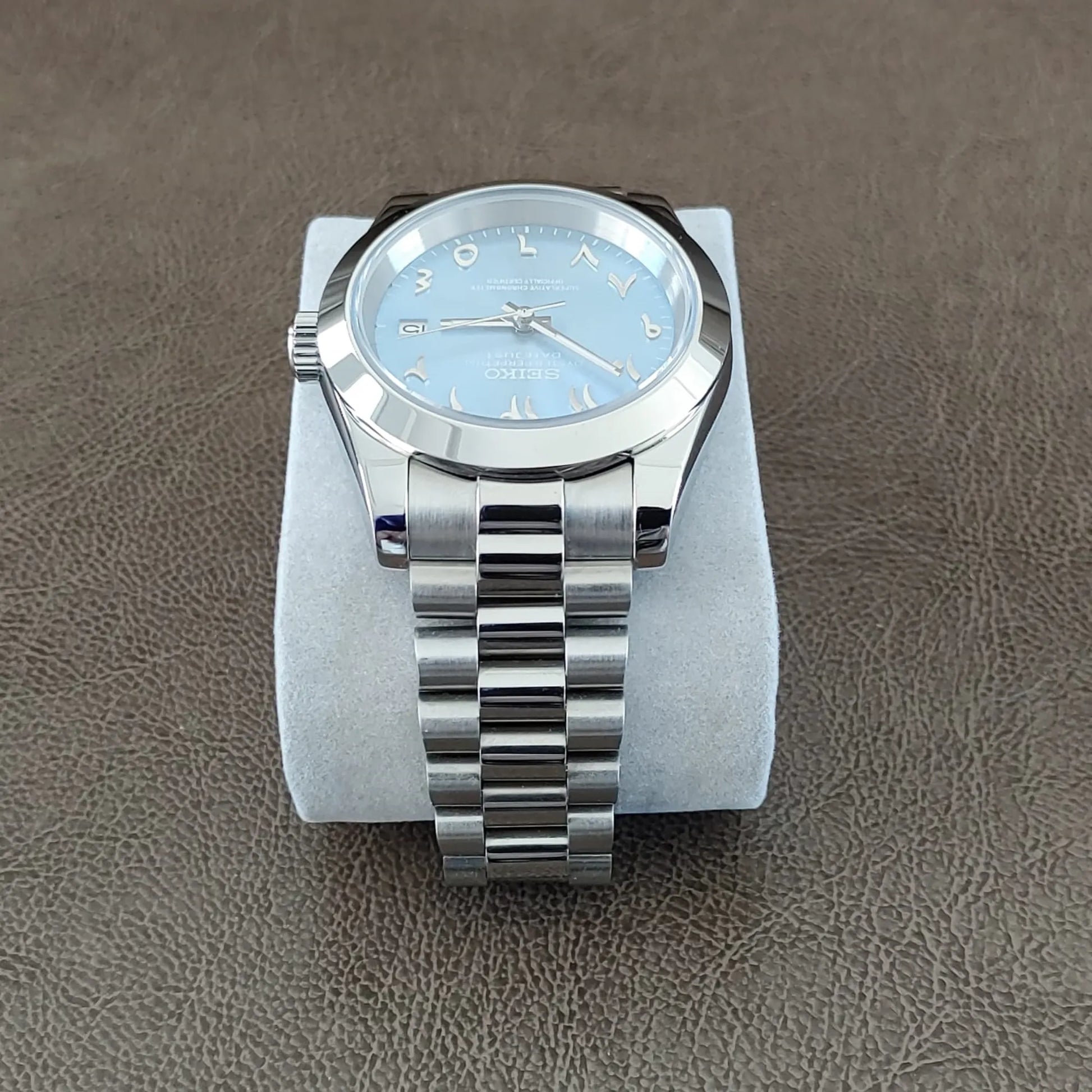 Seiko watch with 39mm platinum case, fluted bezel, ice blue dial, Arabic numerals, and silver Jubilee bracelet.