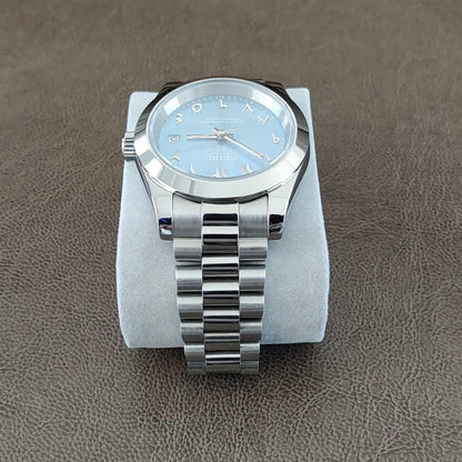 Seiko wristwatch with 39mm stainless steel case, ice blue dial, Arabic numerals, and silver President bracelet strap.