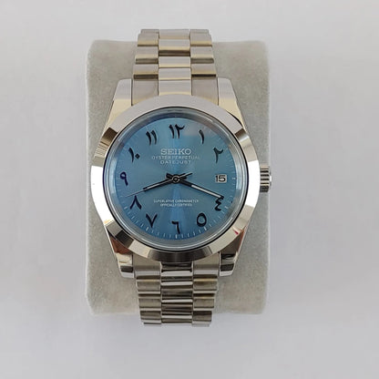 Seiko 39mm watch with ice blue Arabic dial and stainless steel president bracelet strap.