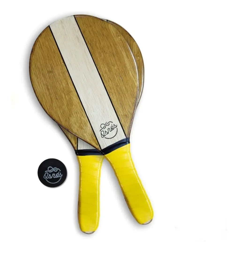 Wooden frescobol paddle rackets with yellow handles and black logo on white stripe, paired with a black ball.
