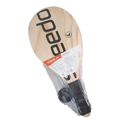 Wooden paddleball paddle with large black Speedo logo and black grip handle wrapped in plastic packaging.