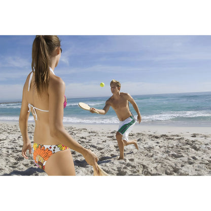 Wooden frescobol paddles with rounded edges and perforations, used for beach paddleball game.