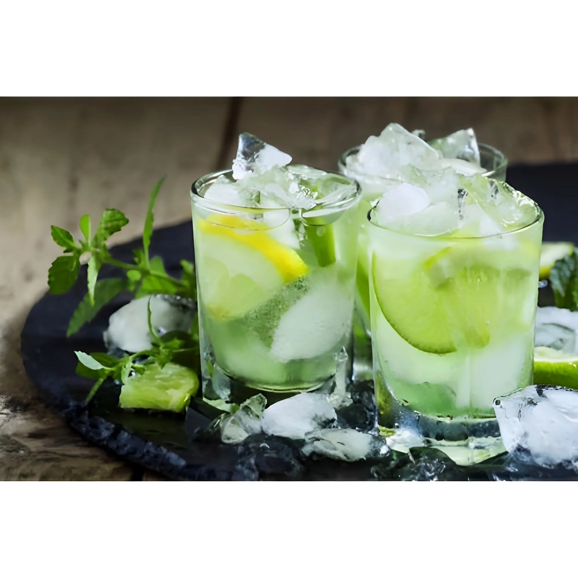 Two glasses of caipirinha with lime wedges, crushed ice, and green garnish on a round black tray.