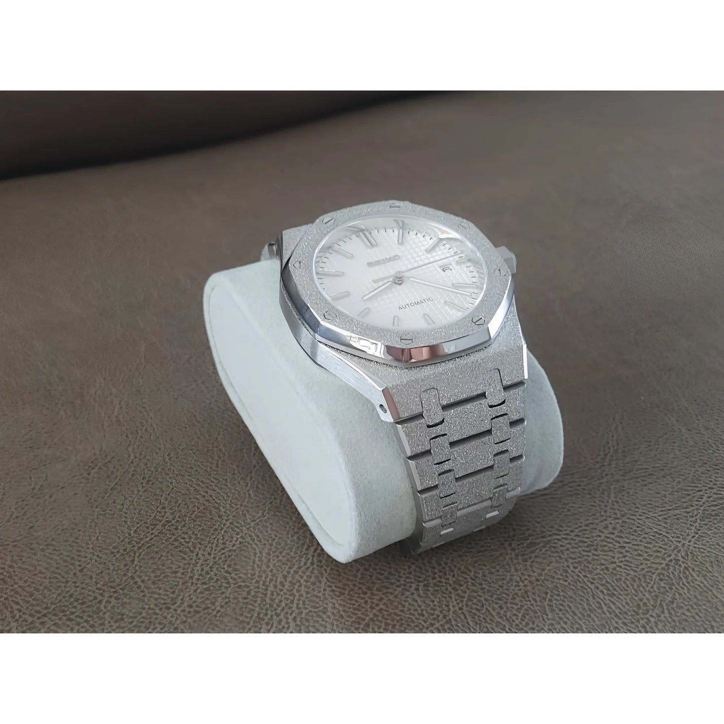 Seiko NH35 wristwatch with frosted white dial, stainless steel Royal Oak style bracelet, and silver-tone case on white.
