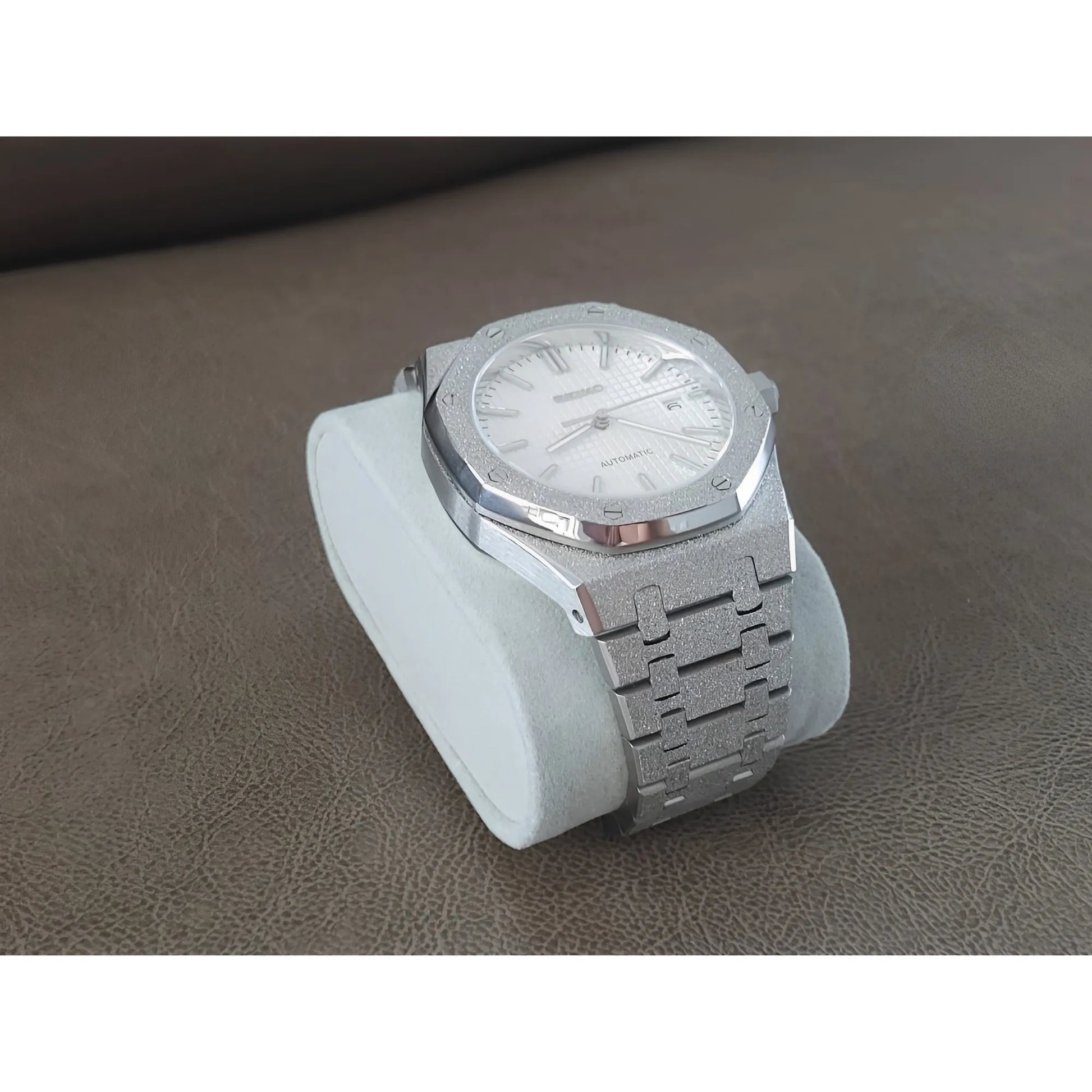 Seiko NH35 wristwatch with frosted white dial, stainless steel Royal Oak style bracelet, and silver-tone case on white.