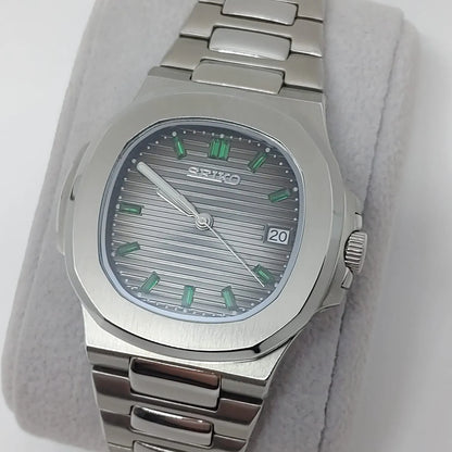 Seiko NH35 watch with 40mm stainless steel case, silver textured dial, green baguette hour markers, date window at 3.