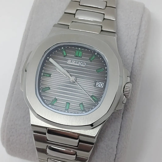 Seiko NH35 watch with 40mm stainless steel case, silver textured dial, green baguette hour markers, date window at 3.