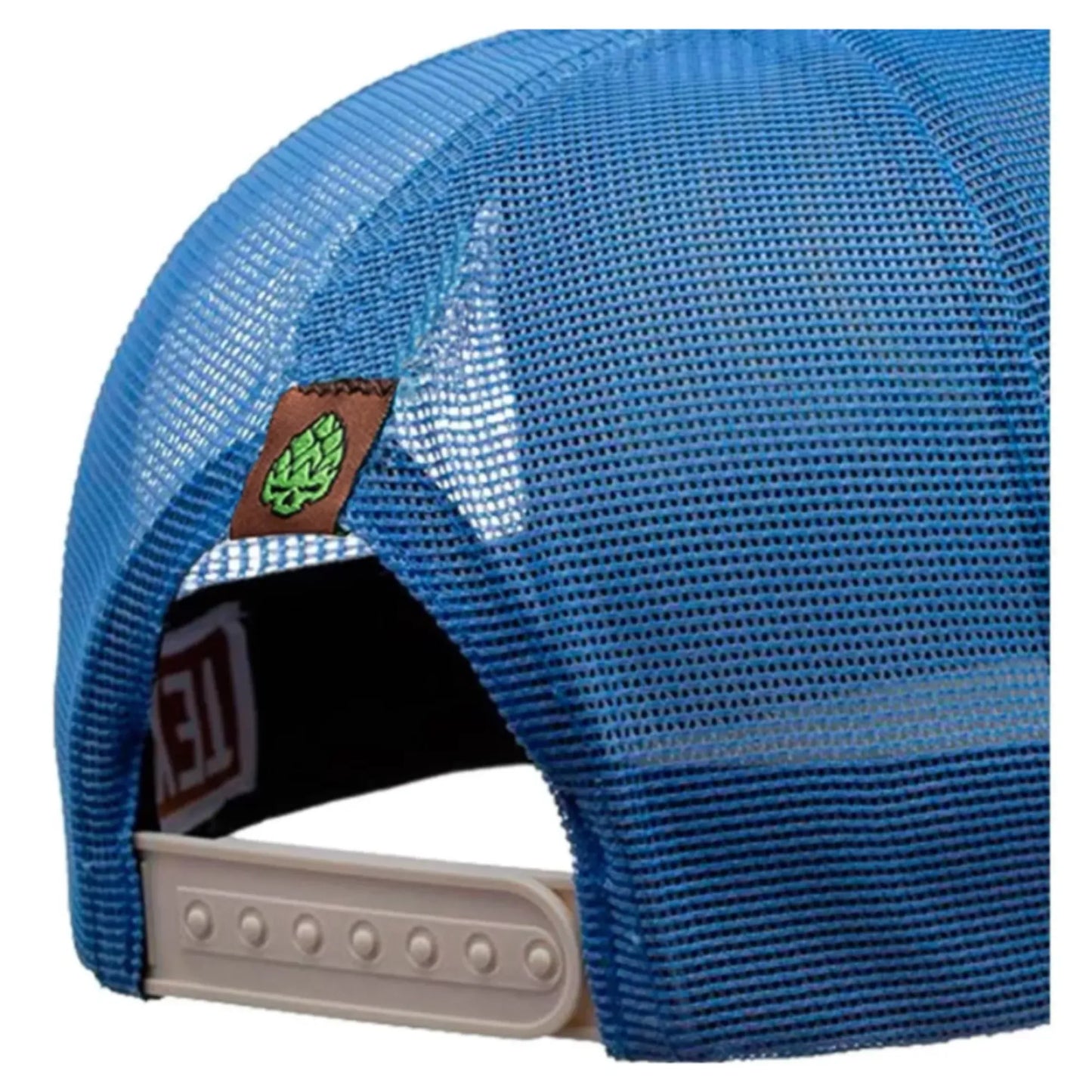 Blue mesh trucker hat with adjustable beige snapback and small green leaf patch on side.