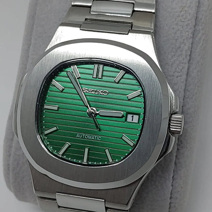 Seiko stainless steel watch with a green striped dial, silver hour markers, date window, and silver hands.