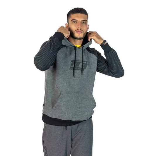 Gray and black FuelTech FTE Electric Power hoodie with quilted black sleeves, worn by male model adjusting hood.