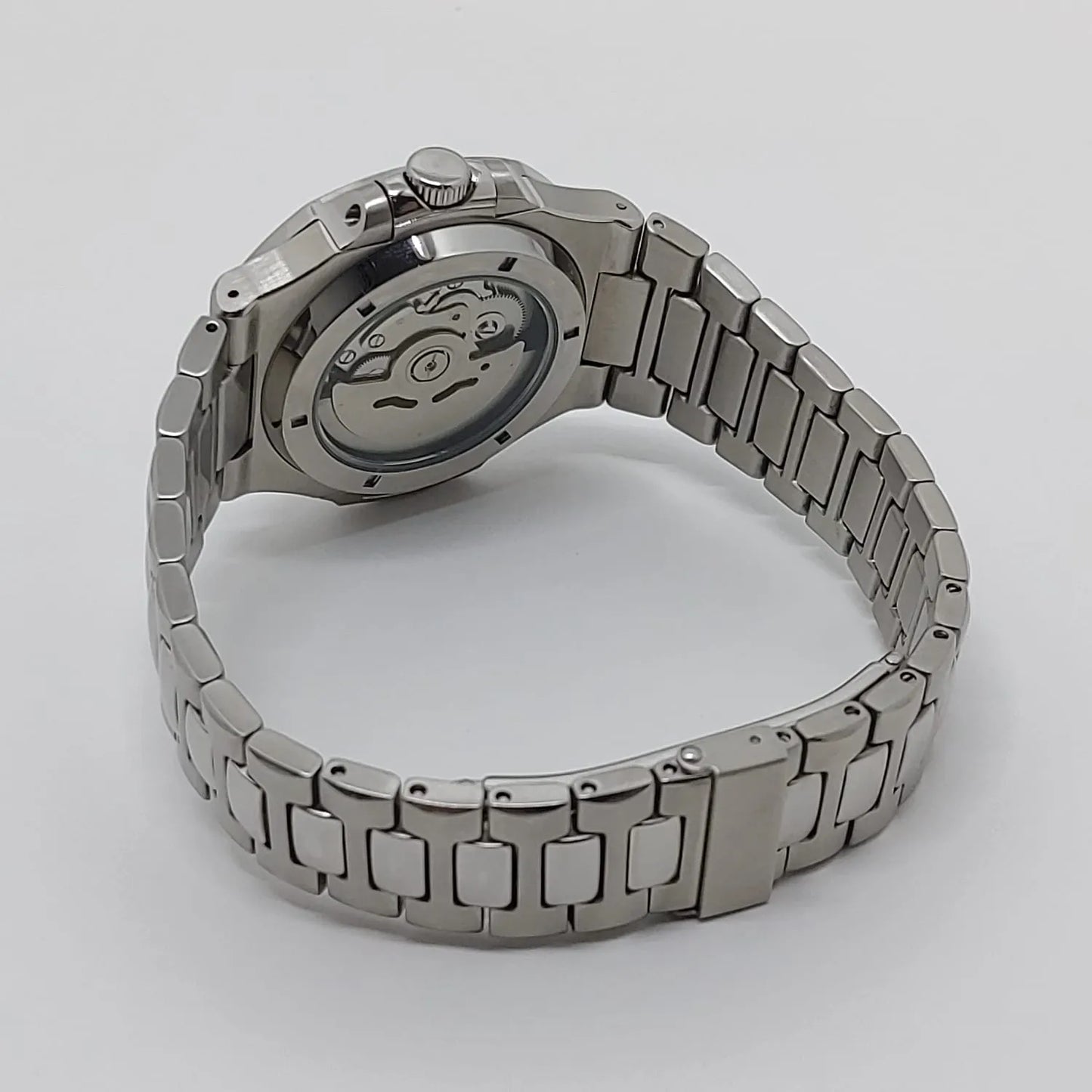 Seiko NH35 watch with stainless steel bracelet and exhibition case back showing mechanical movement.