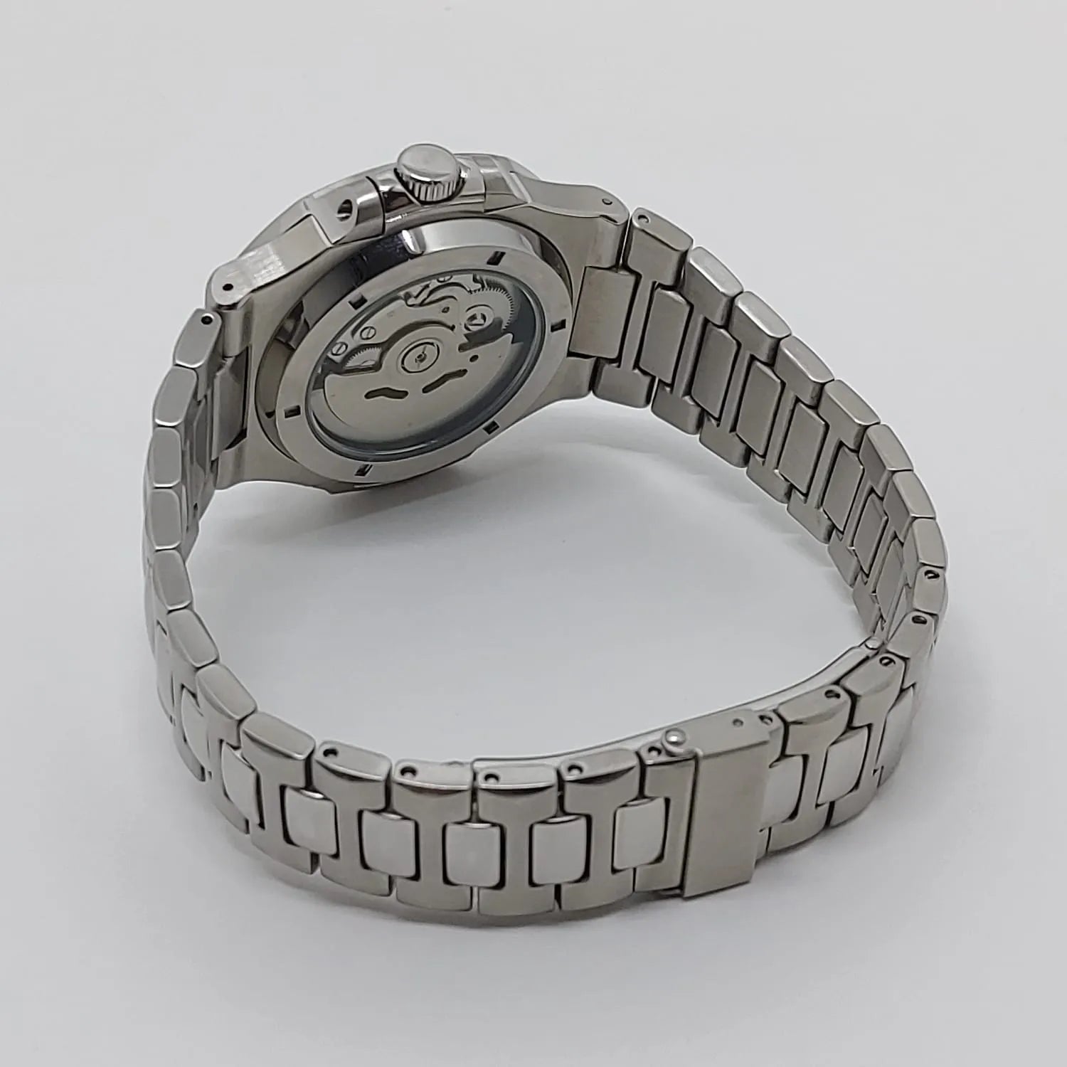 Seiko NH35 watch with stainless steel bracelet and exhibition case back showing mechanical movement.