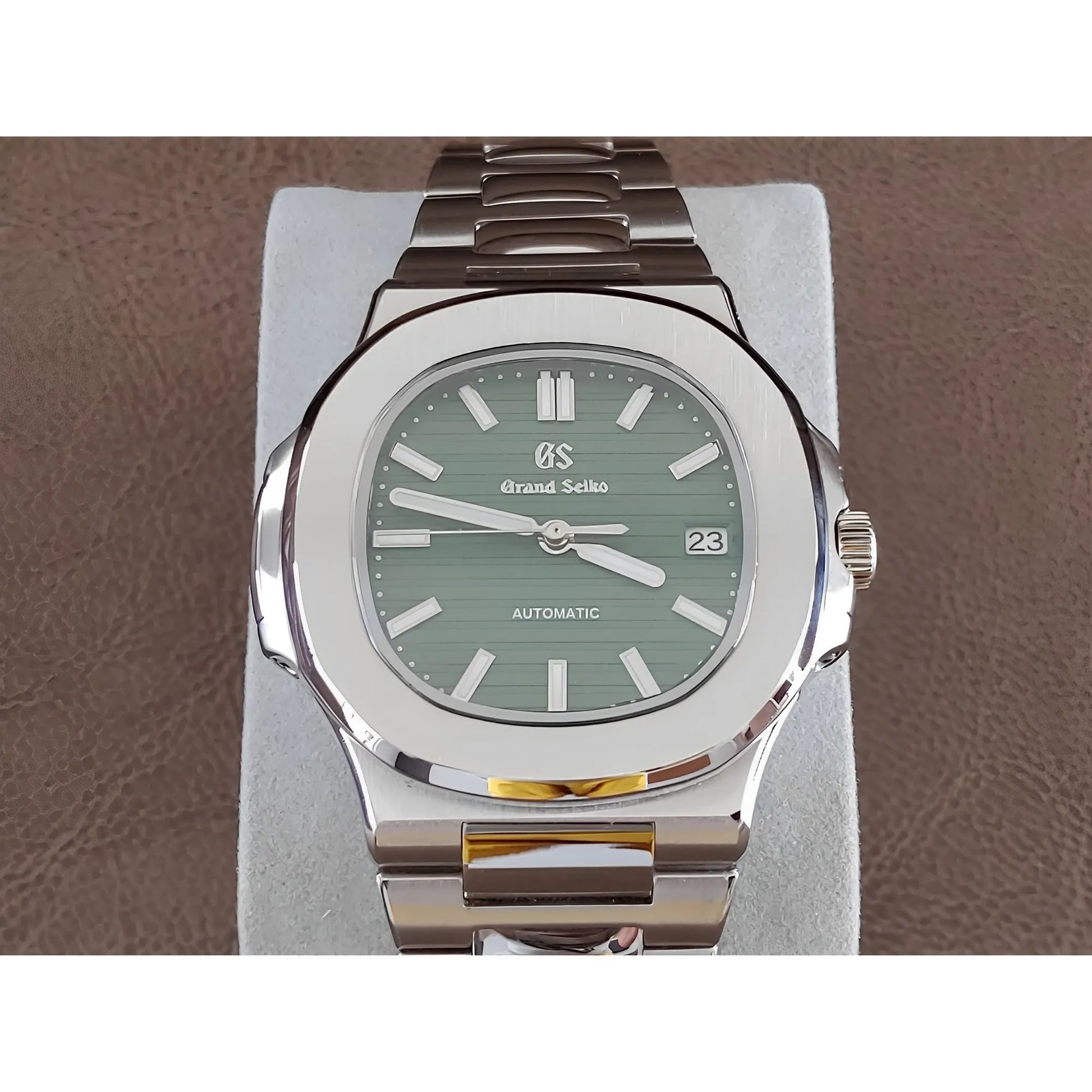 Seiko NH35 wristwatch with olive green dial, stainless steel case and bracelet, luminous markers, and date display at 3.