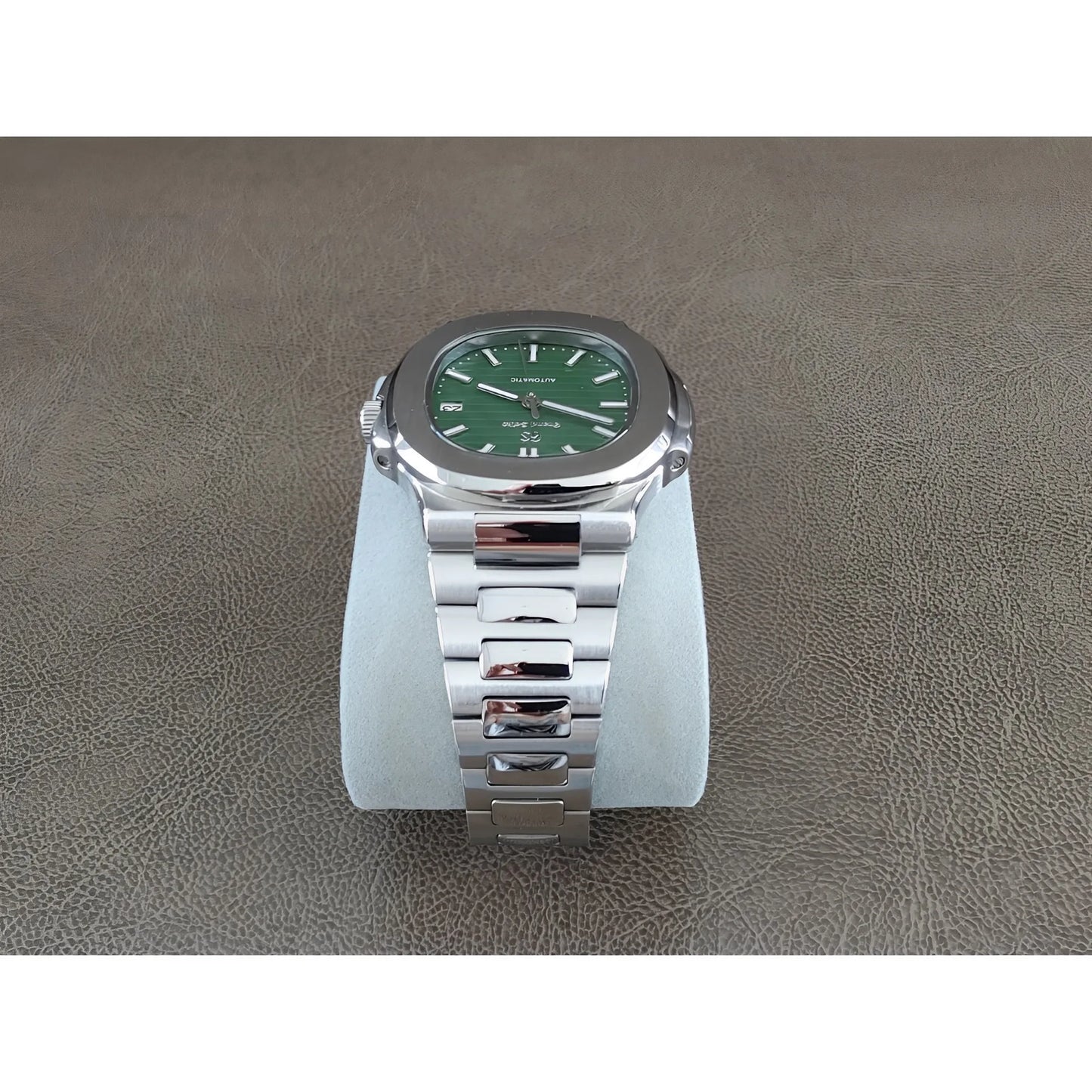 Seiko NH35 stainless steel watch with olive green dial, rounded square case, and silver link bracelet.