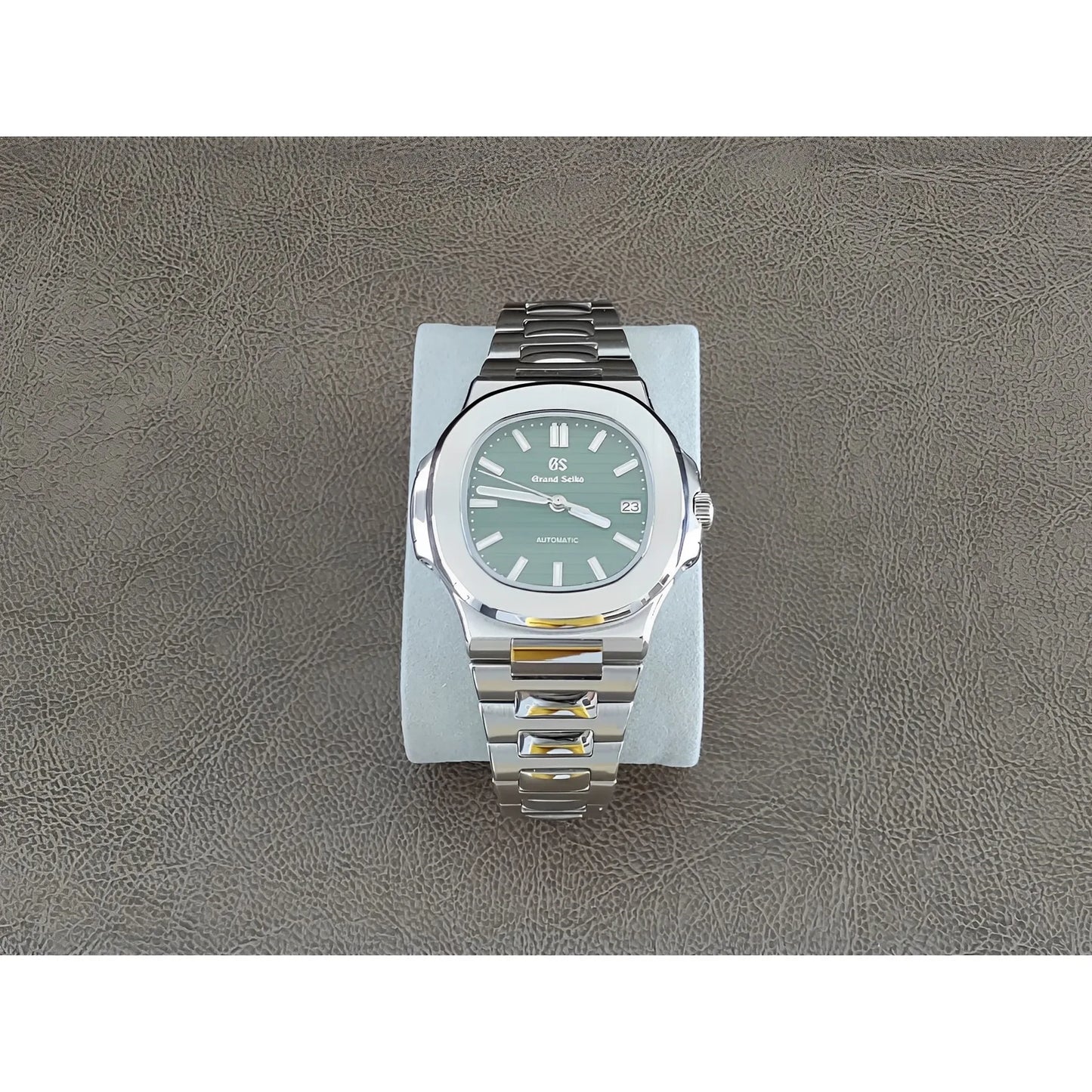 Seiko Nautilus-style 40mm watch with olive green dial, silver hour markers, and stainless steel bracelet.