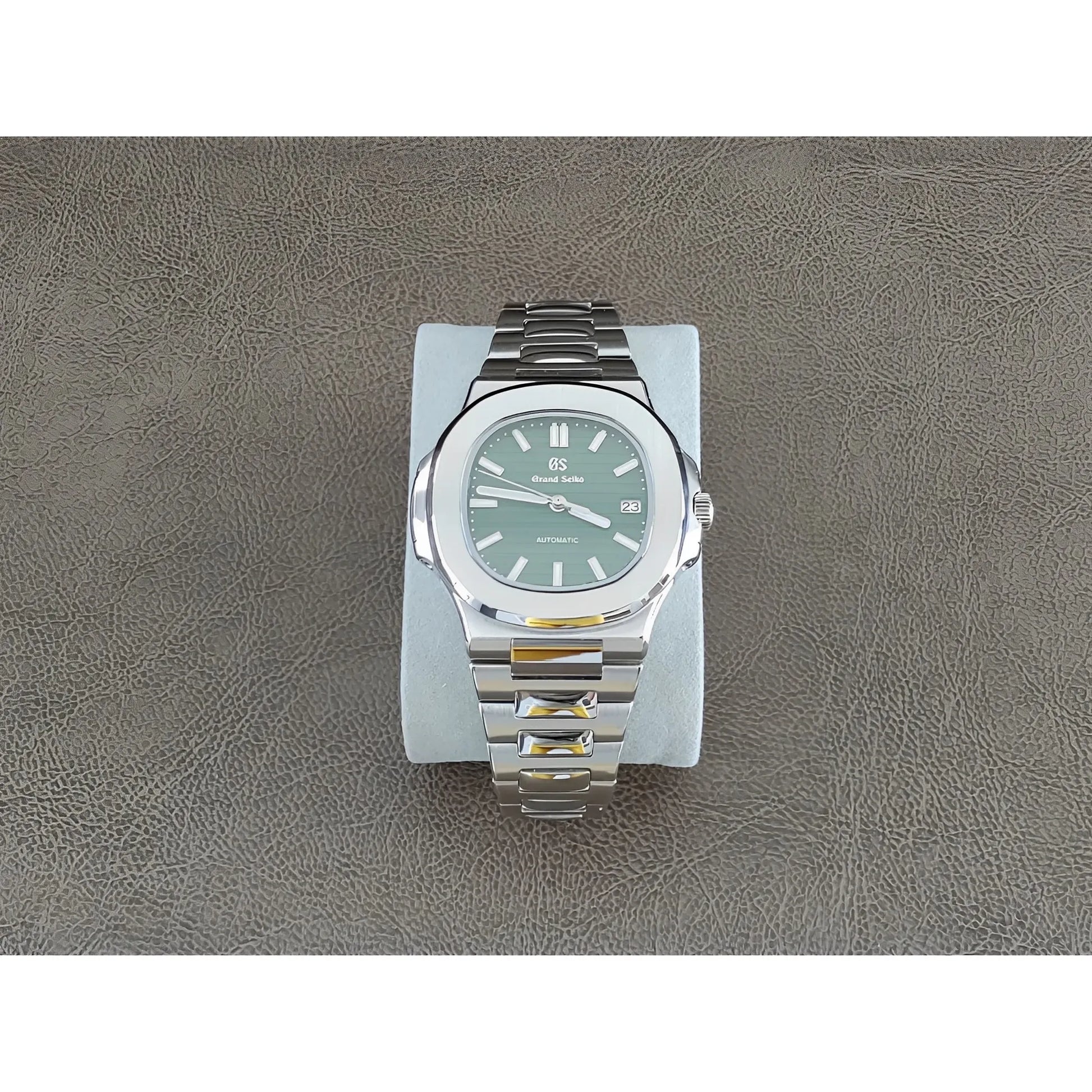 Seiko Nautilus-style 40mm watch with olive green dial, silver hour markers, and stainless steel bracelet.