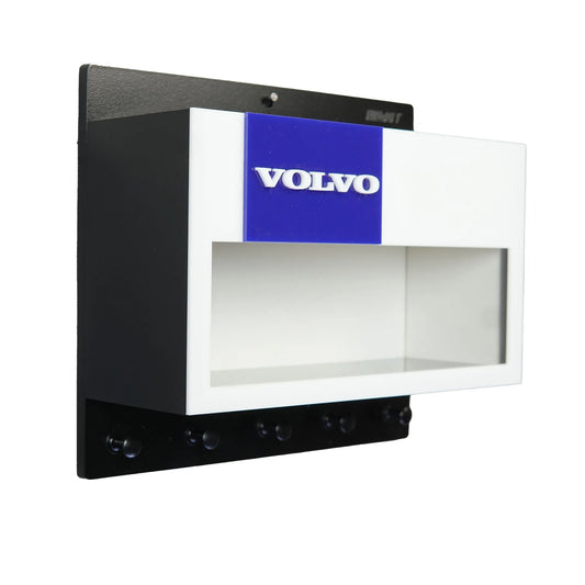 Black wall-mounted key hook rack with white and blue Volvo scale model car display case and four hooks.