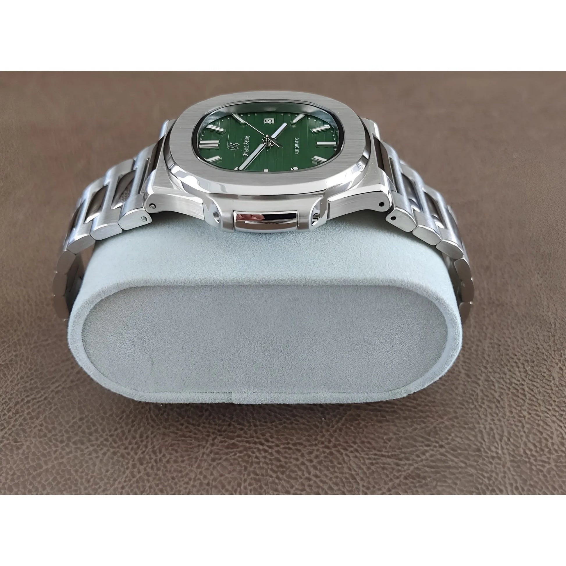 Stainless steel Seiko watch with 40mm olive green dial and silver metal bracelet on gray cushion.