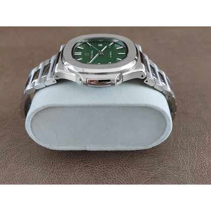 Stainless steel Seiko watch with 40mm olive green dial and silver metal bracelet on gray cushion.