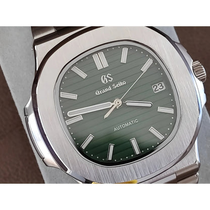 Grand Seiko NH35 Nautilus watch with 40mm brushed stainless steel case and olive green textured dial.