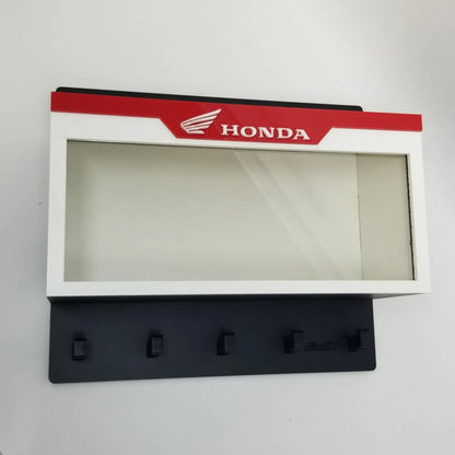 Honda wall-mounted key hook rack with five black hooks and a white display case featuring a red Honda logo panel.