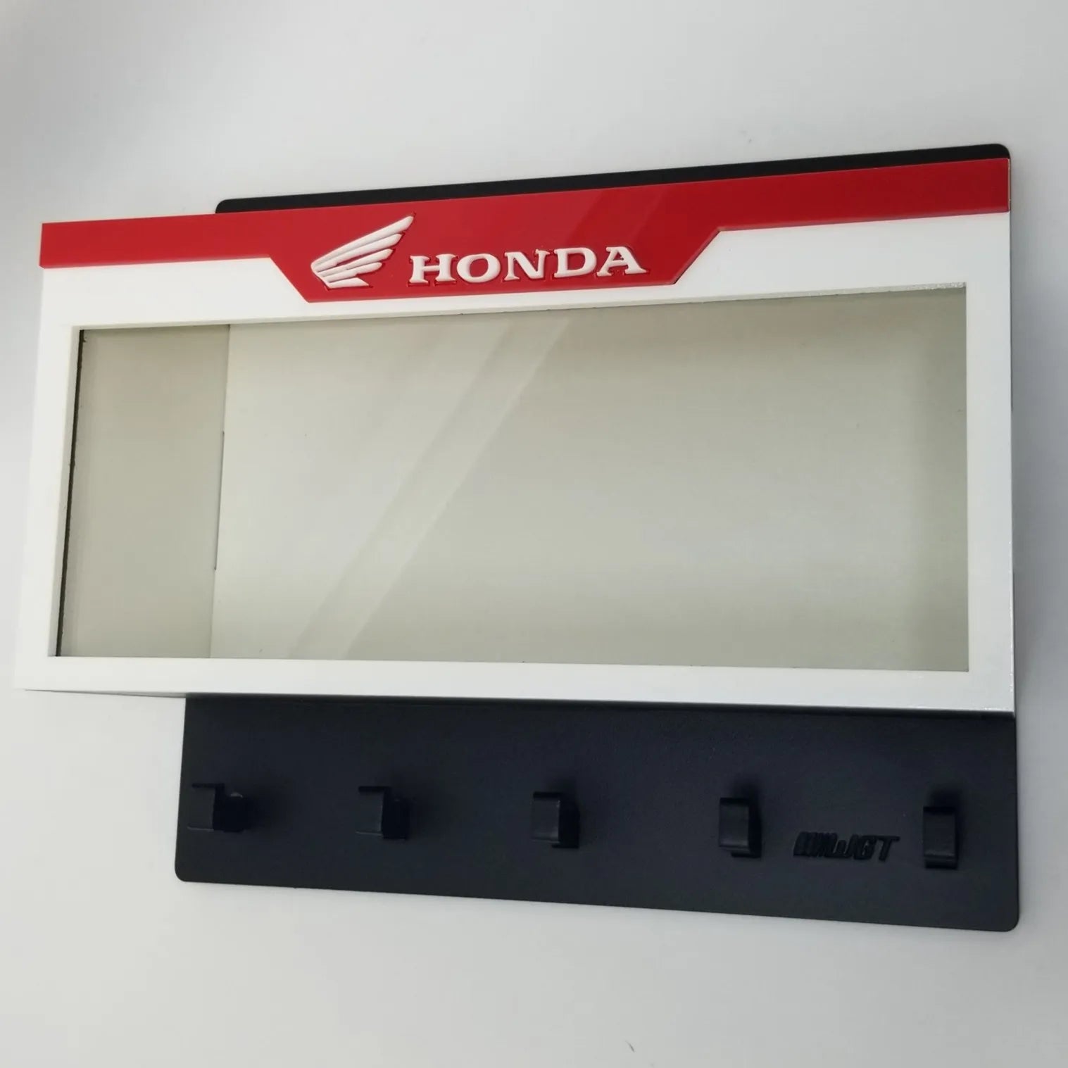 Wall-mounted Honda key hook rack in red, white, and black with a clear display case and five black hooks.