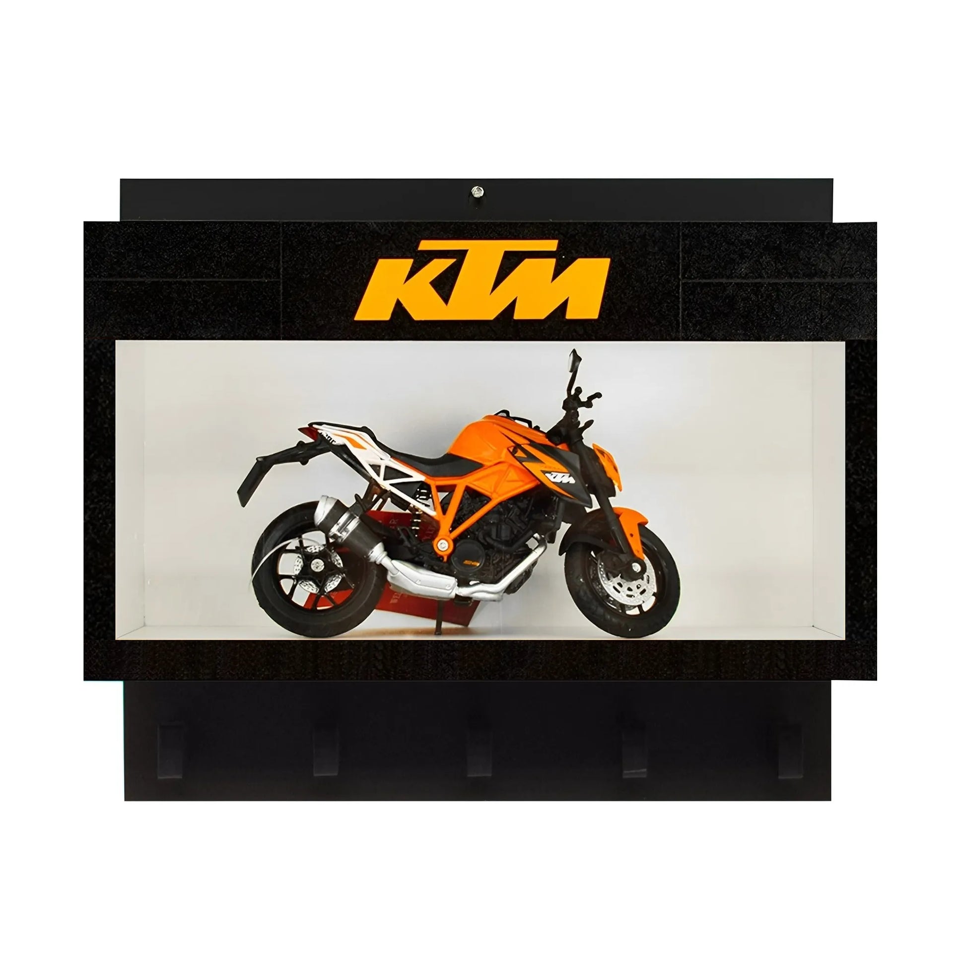 Black wall key hook rack with a clear display case featuring an orange KTM scale model motorcycle and three lower hooks.