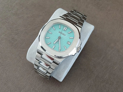 Stainless steel luxury watch with Tiffany green dial, silver hour markers, and link bracelet.