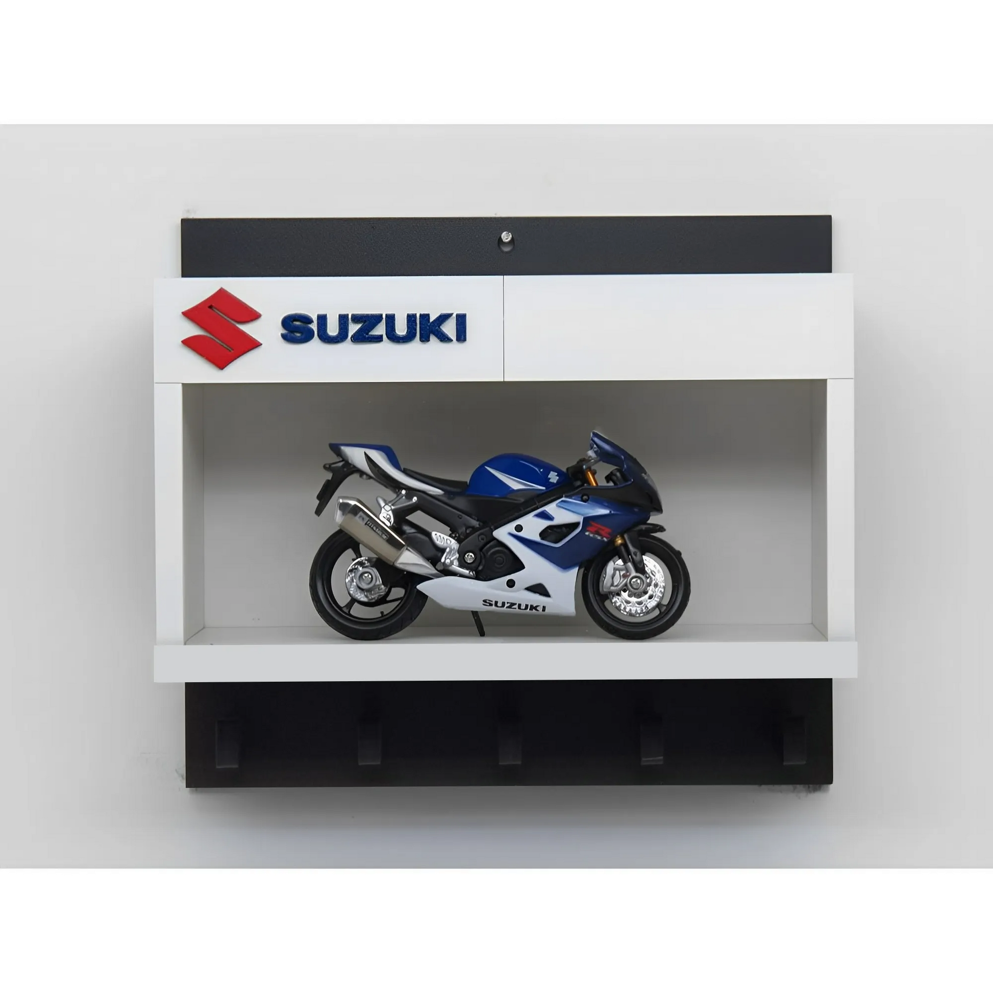 White and black wall key hook rack featuring a detailed blue and silver Suzuki scale model motorcycle and Suzuki logo panel.