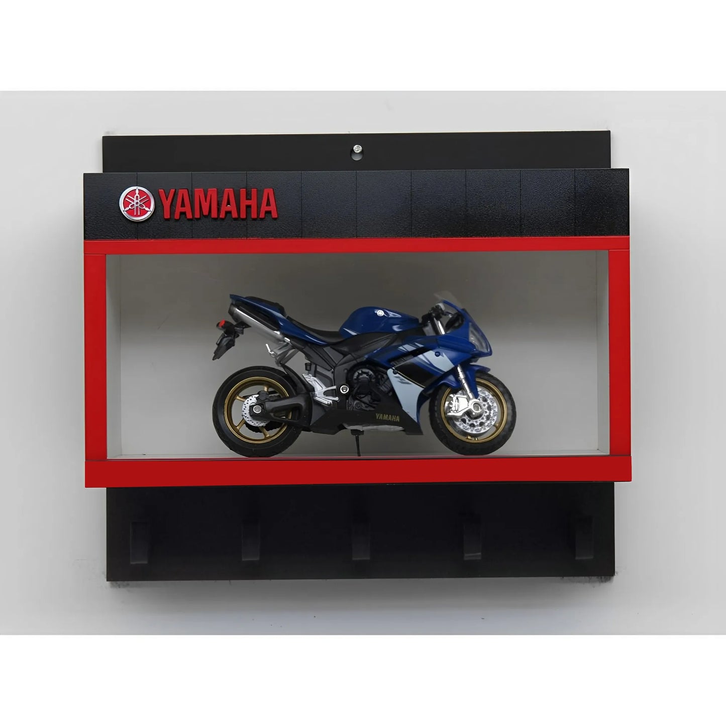 Black Yamaha wall key hook rack with red-bordered display case holding a blue scale model motorcycle.