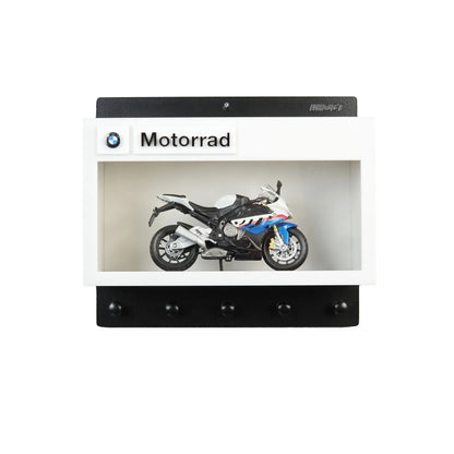 BMW Motorrad wall-mounted key hook rack with black and white frame and a miniature sport motorcycle model inside.