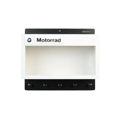 White and black wall-mounted BMW Motorrad key hook rack with five black hooks and logo badge.