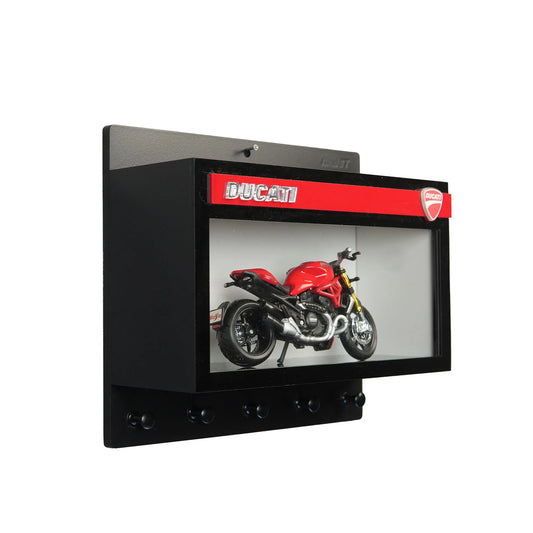 Black wall-mounted key hook rack with glass display case featuring a red Ducati scale model motorcycle and Ducati logo banner.