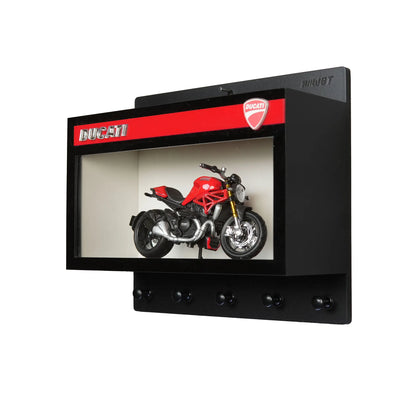 Black wall key hook rack with red Ducati logo and red scale model motorcycle inside display case.